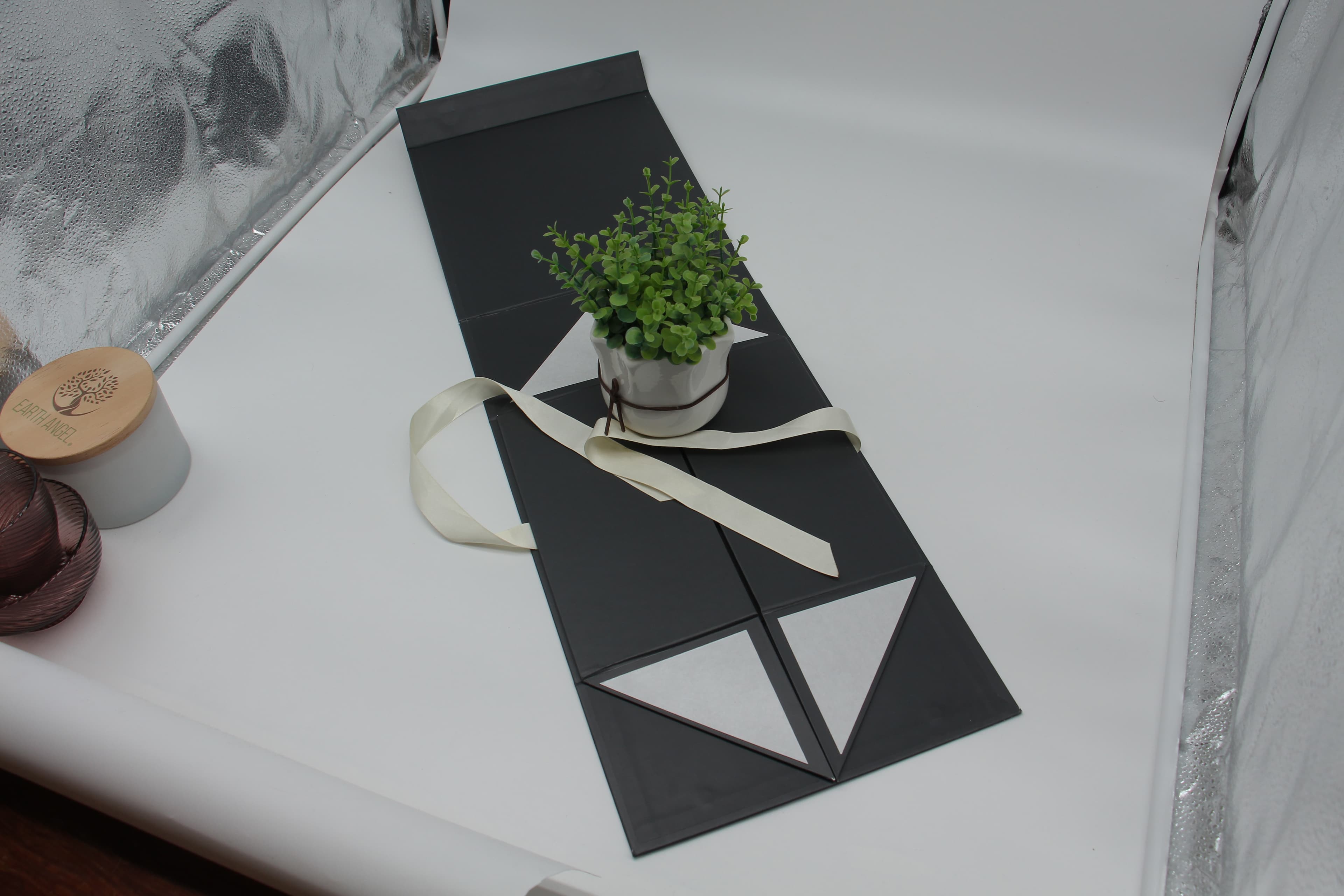 Rectangular origami box holding a pair of glasses